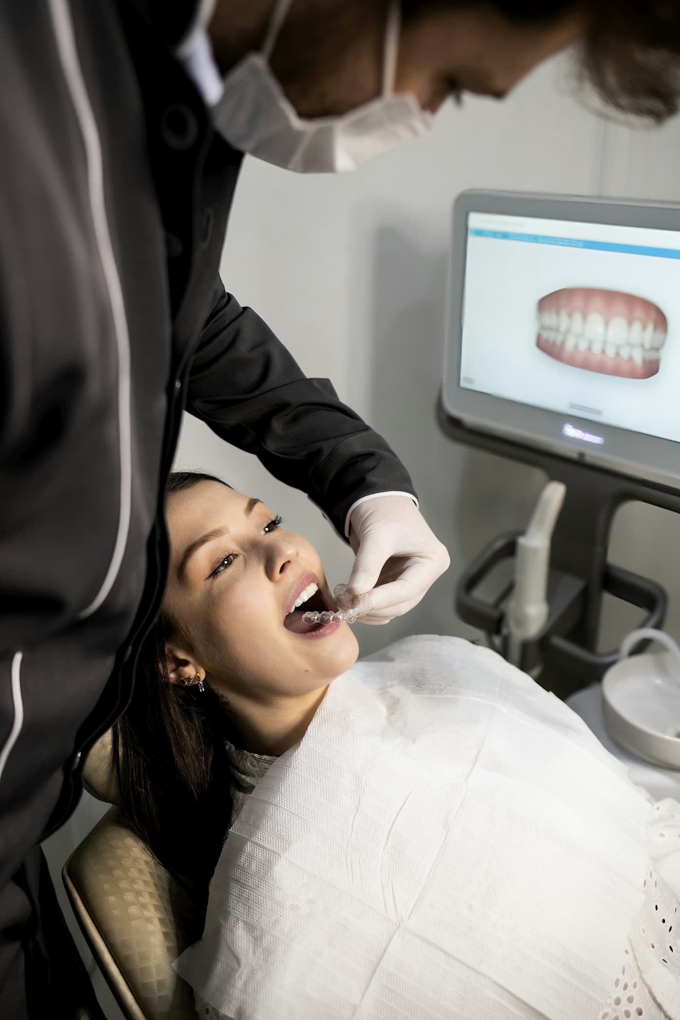 Dentist talking a patient through a scan
