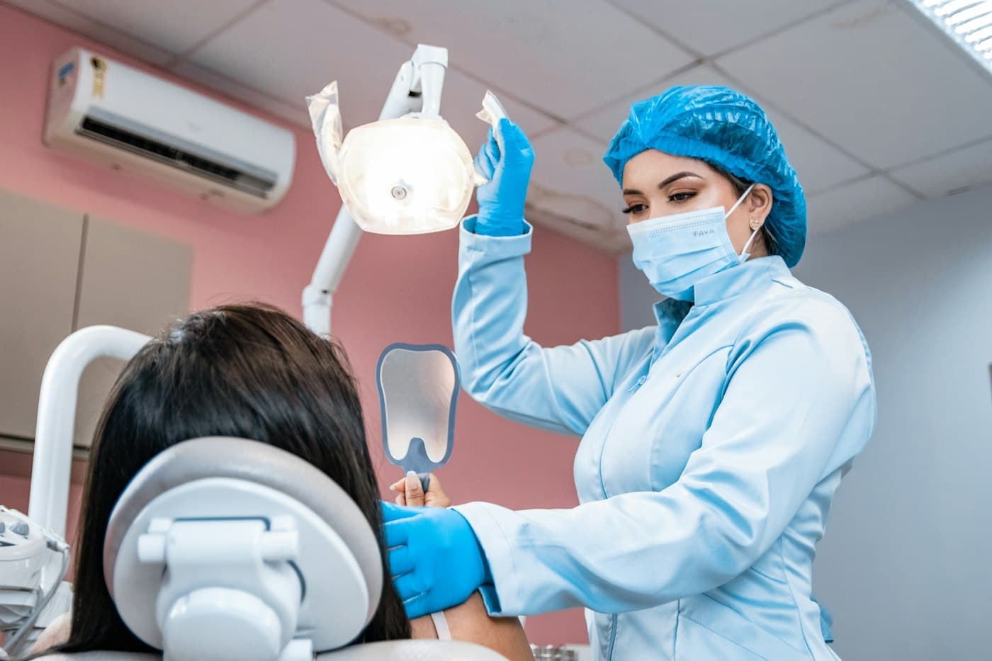 Dentist adjusting the light over a relaxed patient